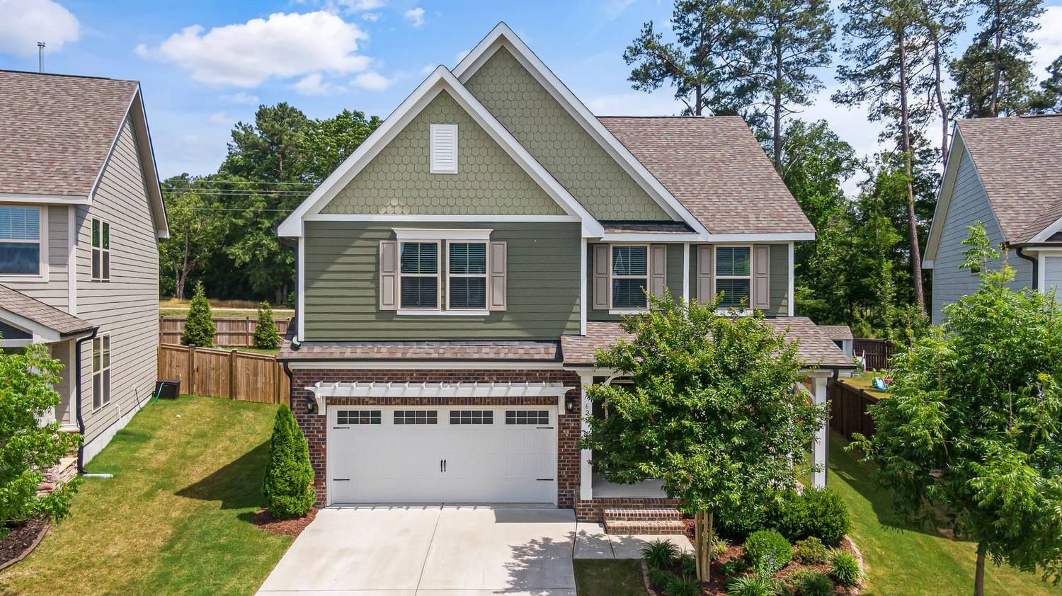 A two storey home with a freshly cut front lawn.